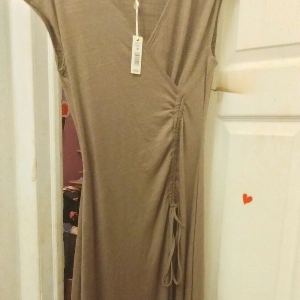 Taupe maxi dress with a rugged bodice on the left side with strings that's tie